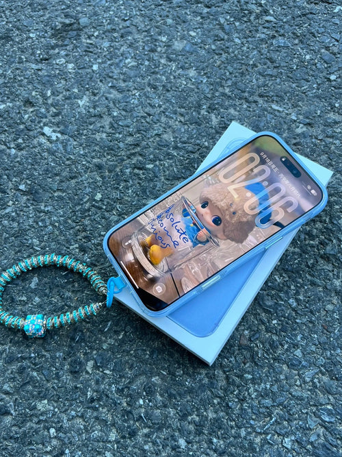Ice blue iPhone case with star design and beaded pendant – second view