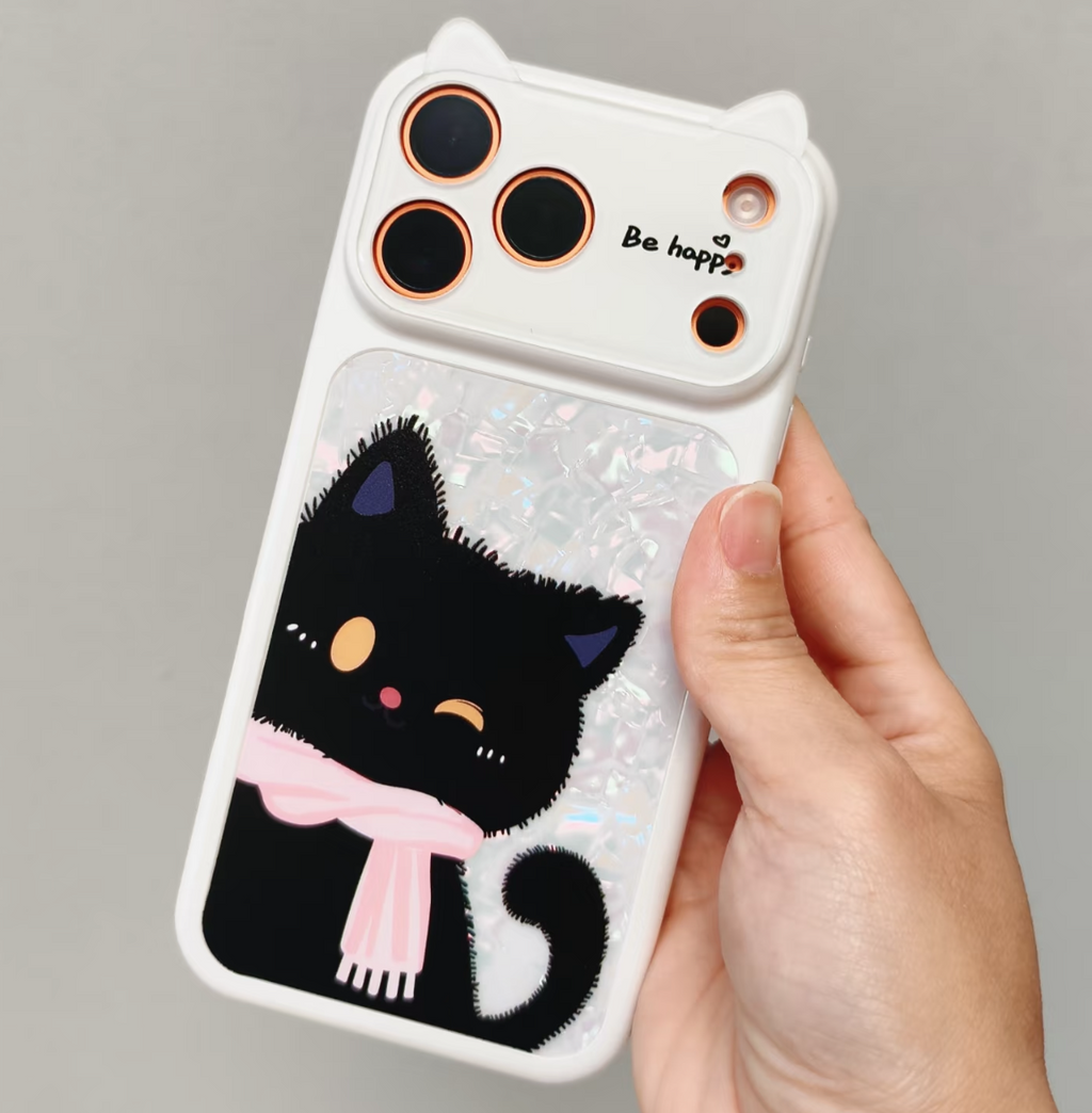 A hand holding a white phone case decorated with a black cartoon cat wearing a pink scarf, set against a plain gray background.