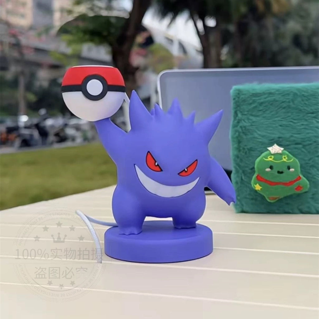 Blue cartoon character with a red and white object on a table outdoors
